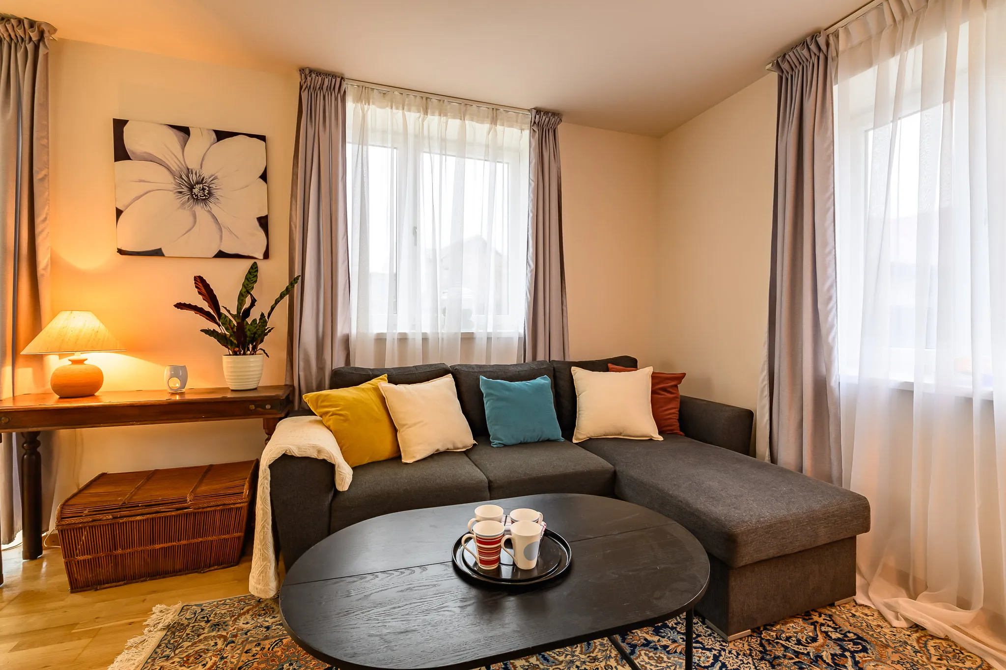 Sitting area with a corner sofa and two windows