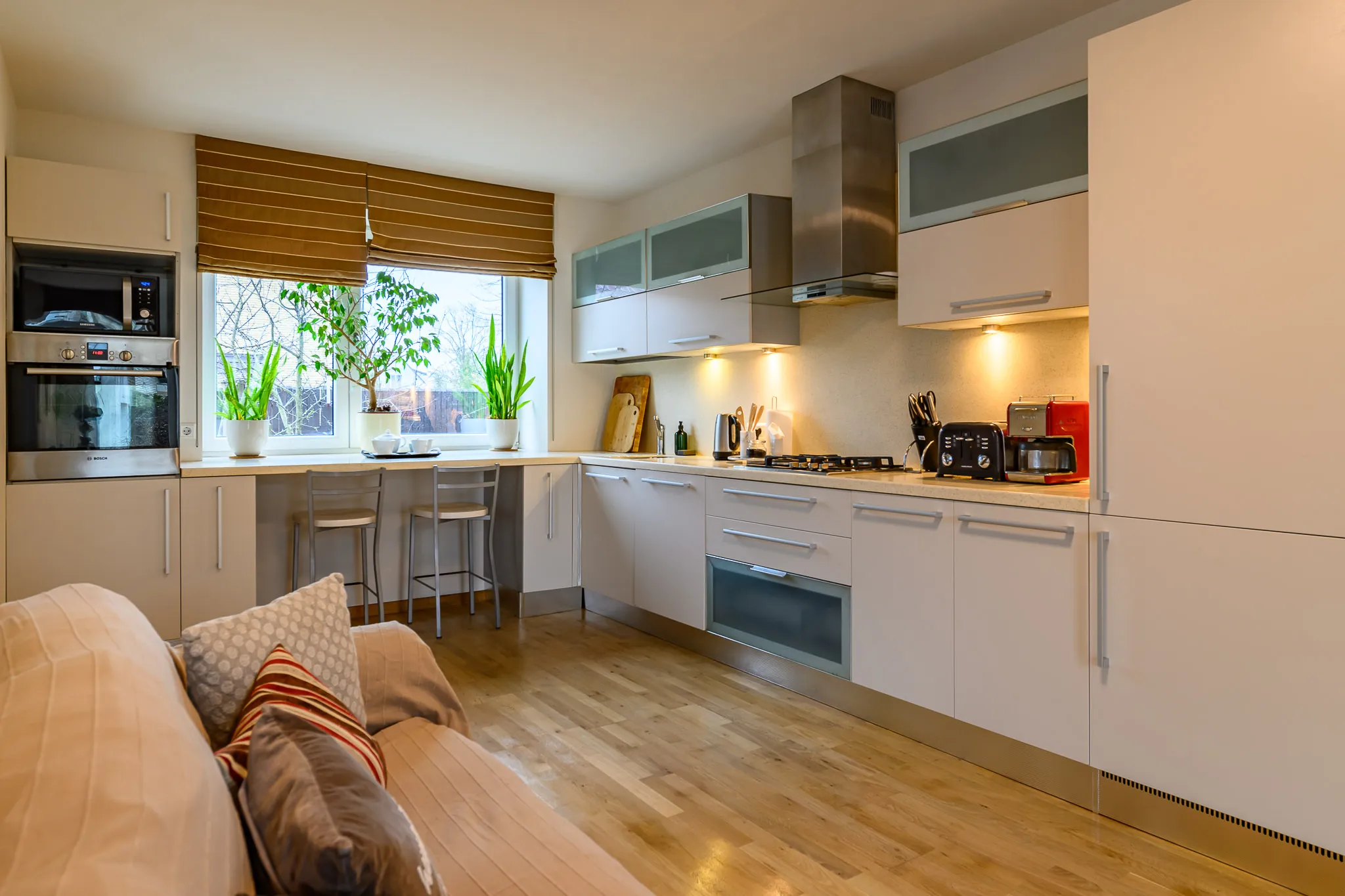 Kitchen with a breakfast bar and a sofa